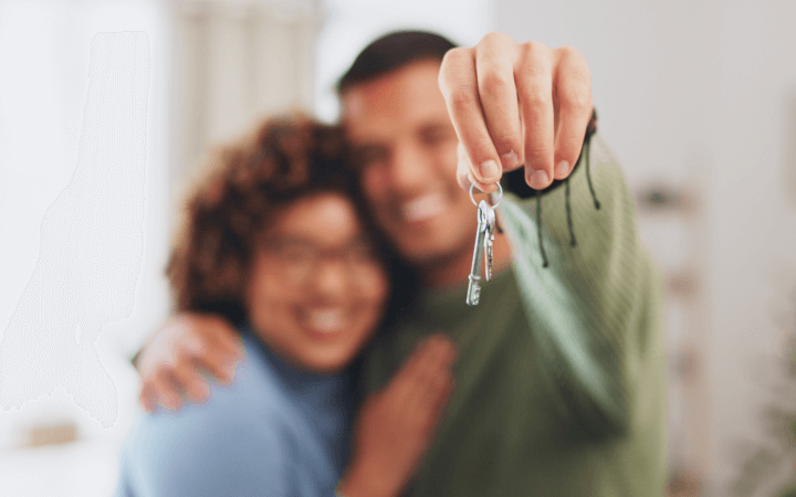 A couple hold 2 keys for their new dual key investment property